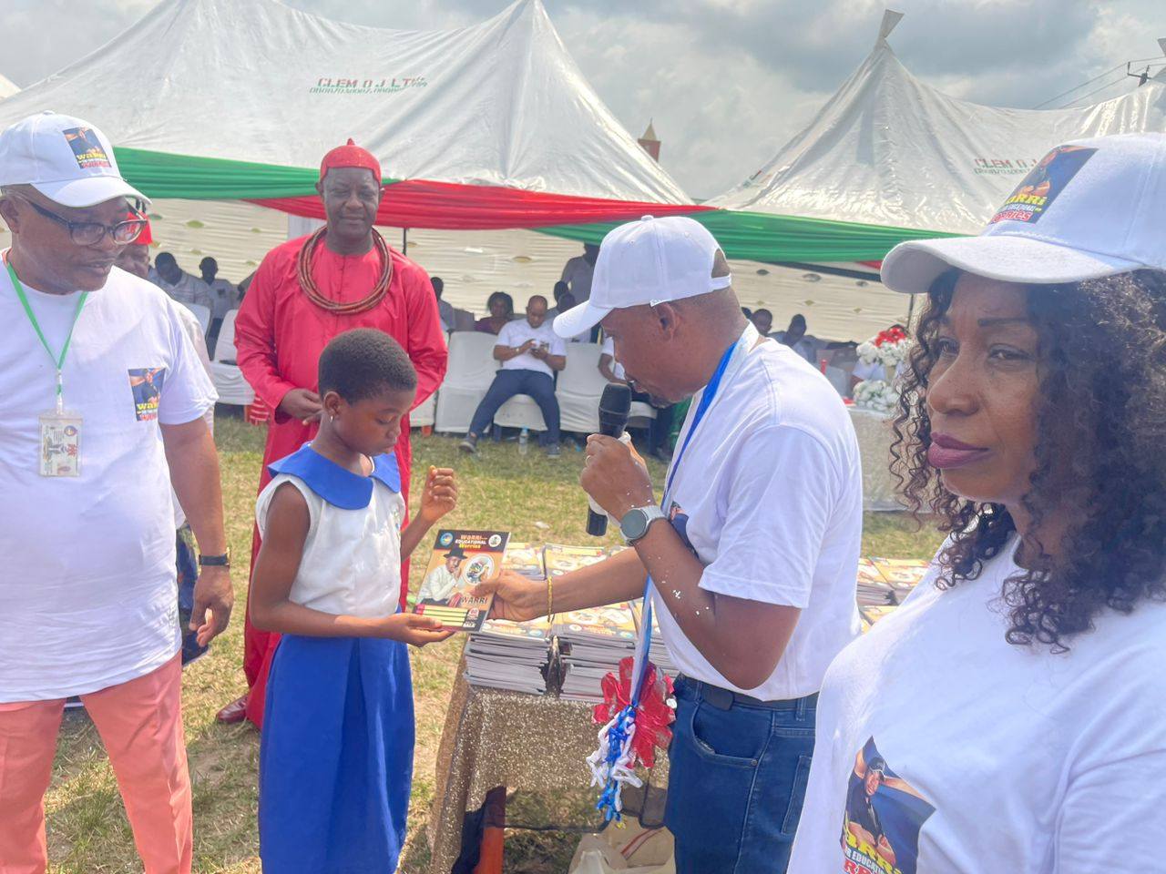 Student receiving exercise books from Chairman